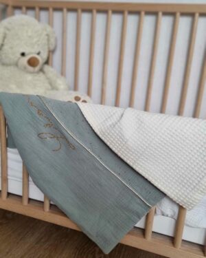 couverture été vert sauge et nid d'abeille écru sur le bord d'un lit